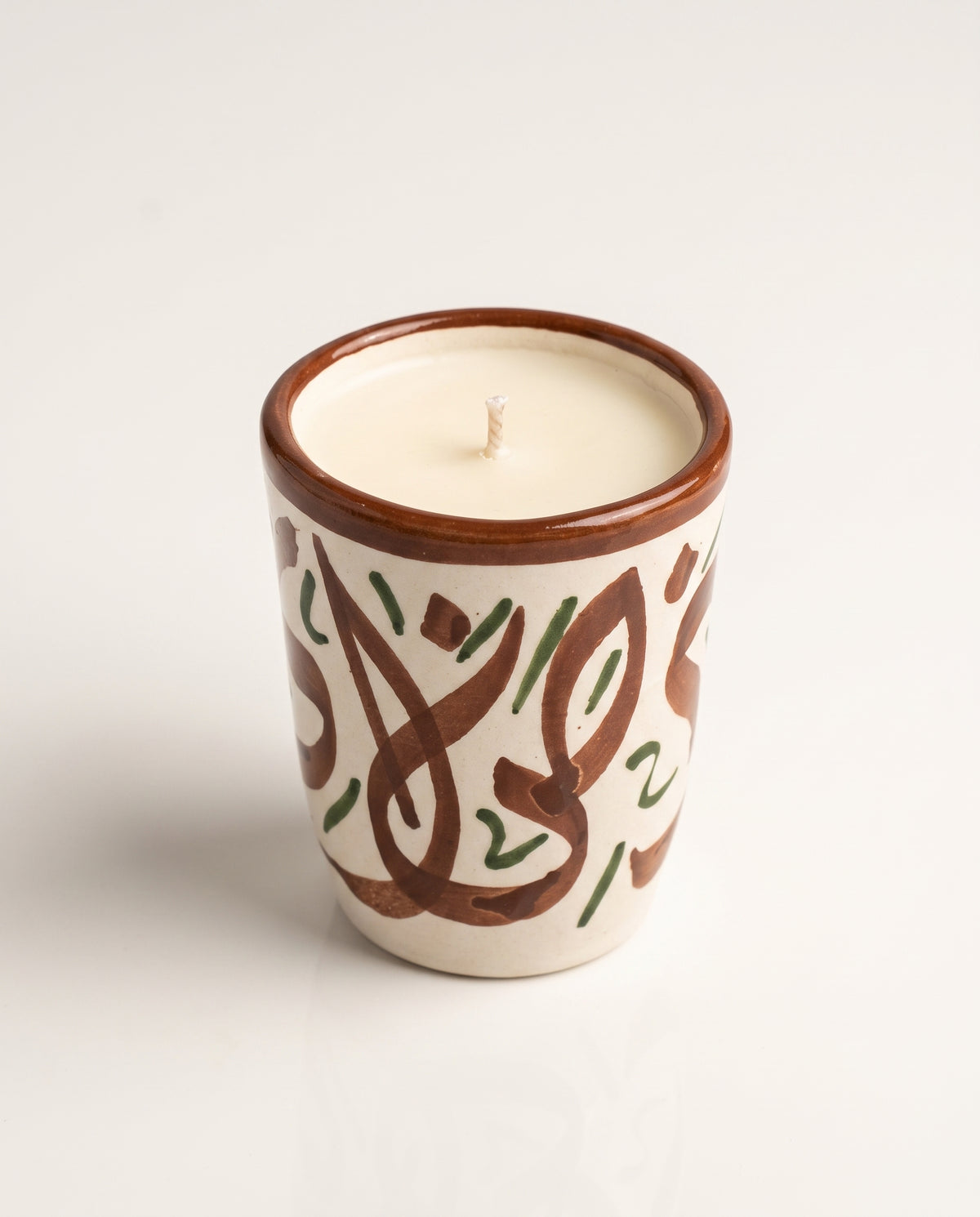 Bougie Sanaa, petit format en terre cuite peint main (calligraphie marron et vert) sur fond neutre, collection Fès My Candles Vibes